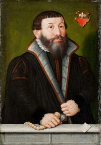 Sixteenth century oil painting of Martin Chemnitz in a talar with a coat of arms and a green behind him. Martin Chemnitz, with a dark hair and a severe, bowl-like haircut, is holding a pomander and/or prayer beads in his right hand. 