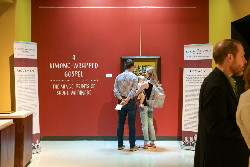 A young family enjoys the Sadao Watanabe exhibit at Concordia Historical Institute on April 15, 2023.
