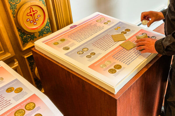 CHI Executive Director Rev. Dr. Daniel Harmelink mocks up one display cube for the upcoming exhibit “Luther Medals and Reformation Coins: Michigan Connections and Collectors.”